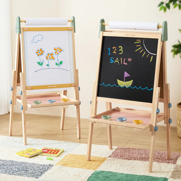 Two children's easels with whiteboard and blackboard surfaces, one with drawings and the other with colorful letters and numbers.
