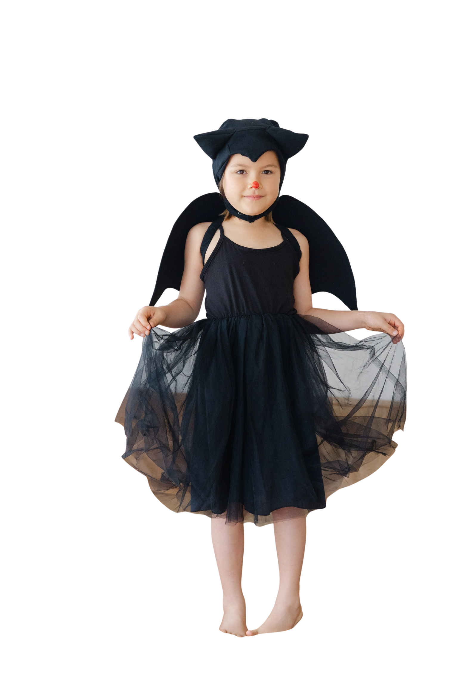 Child wearing a black bat costume with wings on a white background