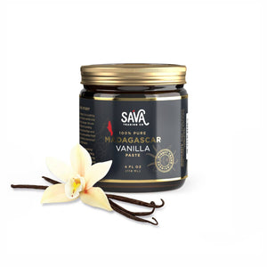 4oz jar of SAVA Pure Madagascar Vanilla Bean Paste with vanilla beans and a vanilla flower on a white background