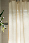 Beige curtain with a plant in the corner