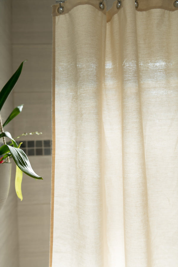 Beige curtain with a plant in the corner