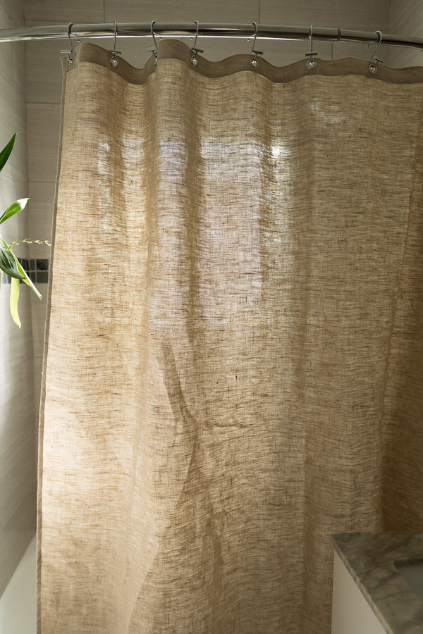Beige textured shower curtain in a bathroom setting
