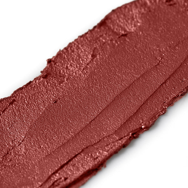 Close-up of a swatch of brown makeup on a white background
