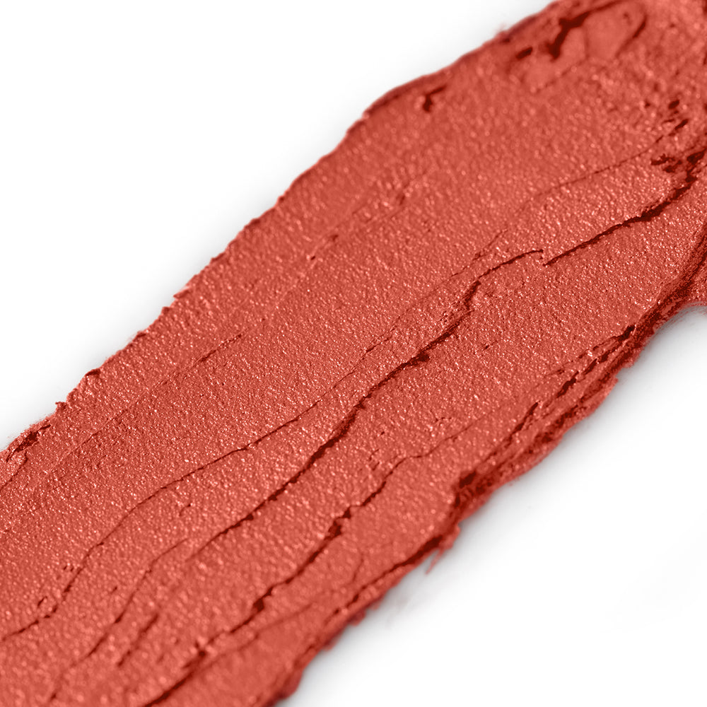Close-up of a swatch of red makeup on a white background
