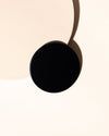Matte black thin metal candle lids displayed on 12 oz Aura candle jars