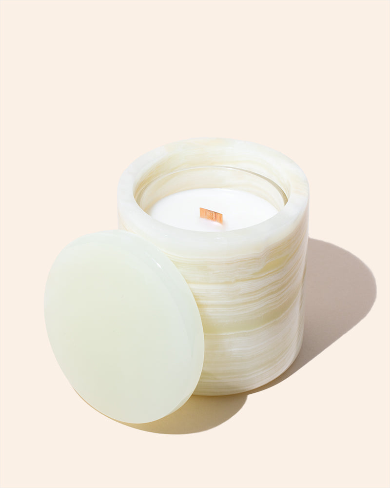 Translucent candle refill insert placed inside a natural stone candle jar