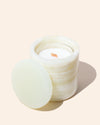 Translucent candle refill insert placed inside a natural stone candle jar