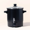 Close-up of makesy® wax melter stainless steel spout pouring melted wax during candle making