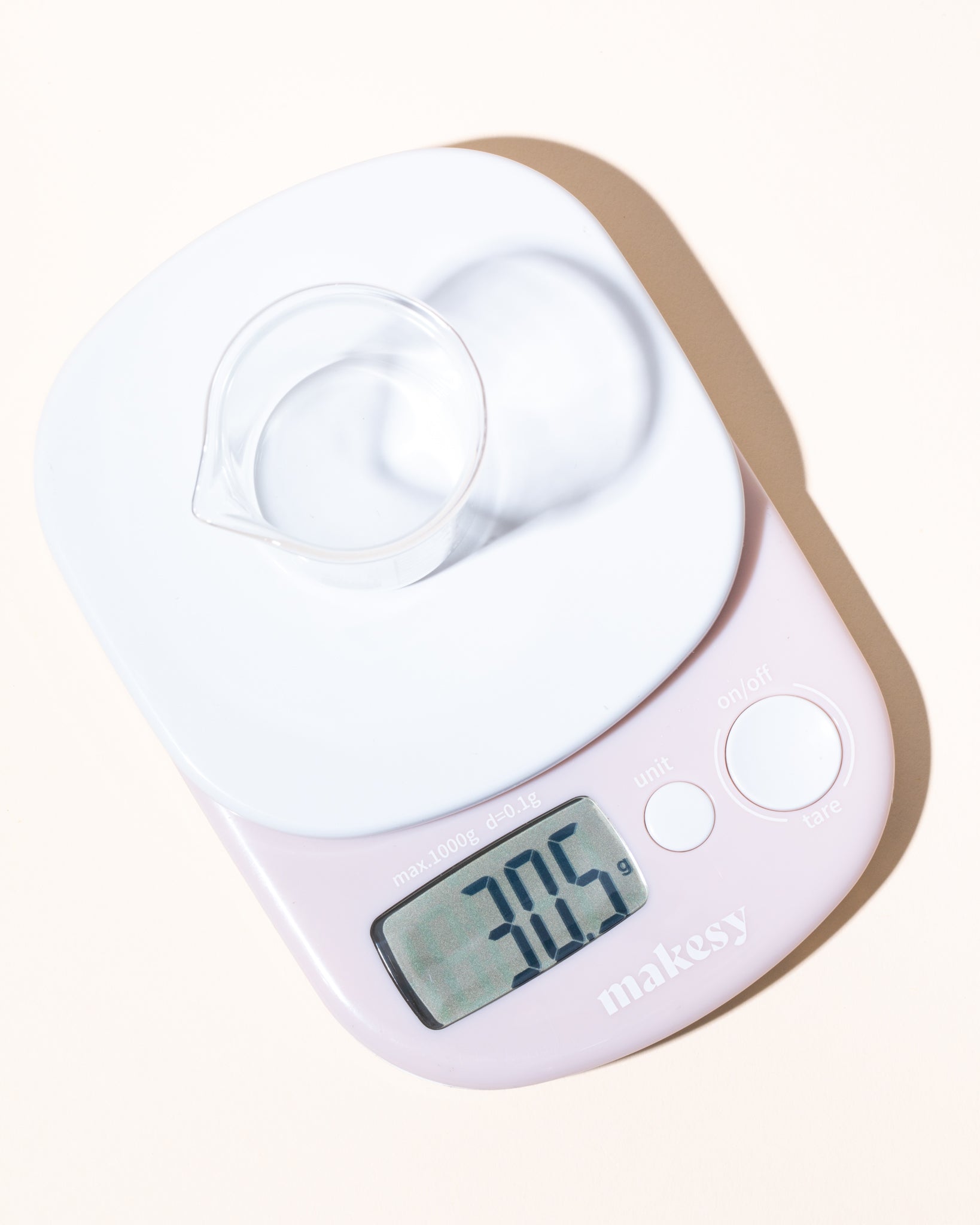 Makesy Pro Digital Scale displaying digital readout — measures in ounces, grams, milliliters, and pounds for maker projects