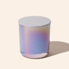 Iridescent glass candle on a light beige background
