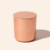 Rose gold cylindrical container on a beige background