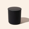 Black cylindrical object on a beige background