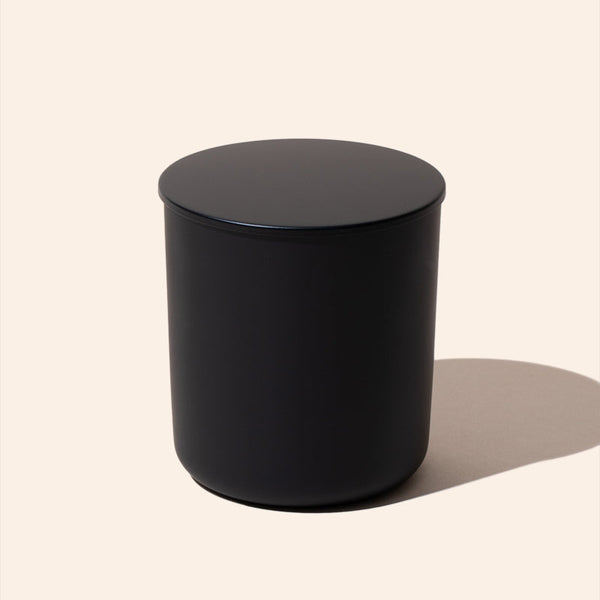 Black cylindrical object on a beige background