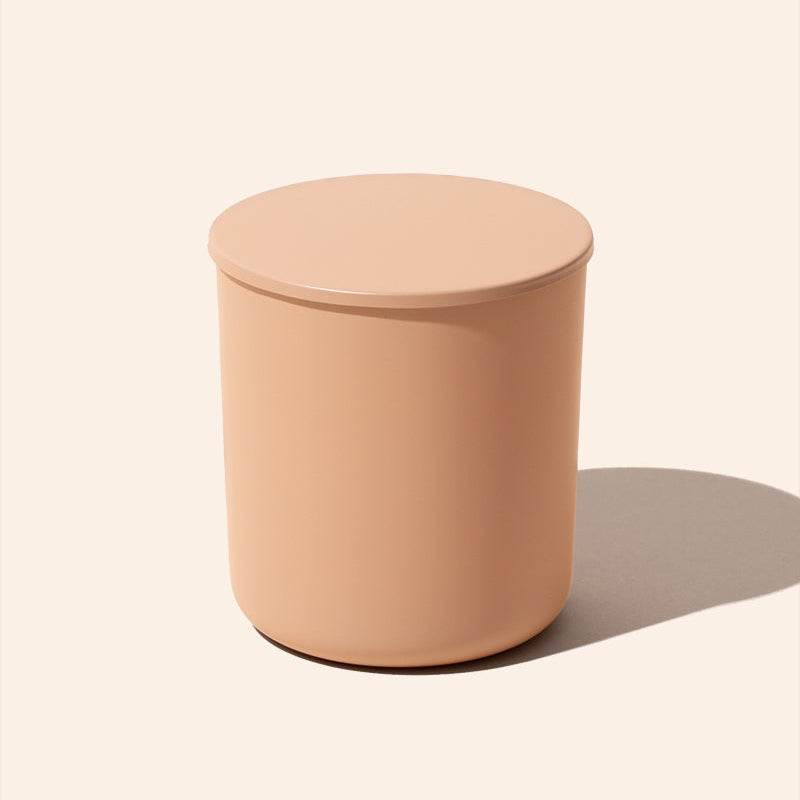 Round peach-colored stool on a light beige background