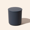 Dark blue cylindrical container on a beige background