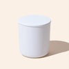 White cylindrical container with a lid on a beige background