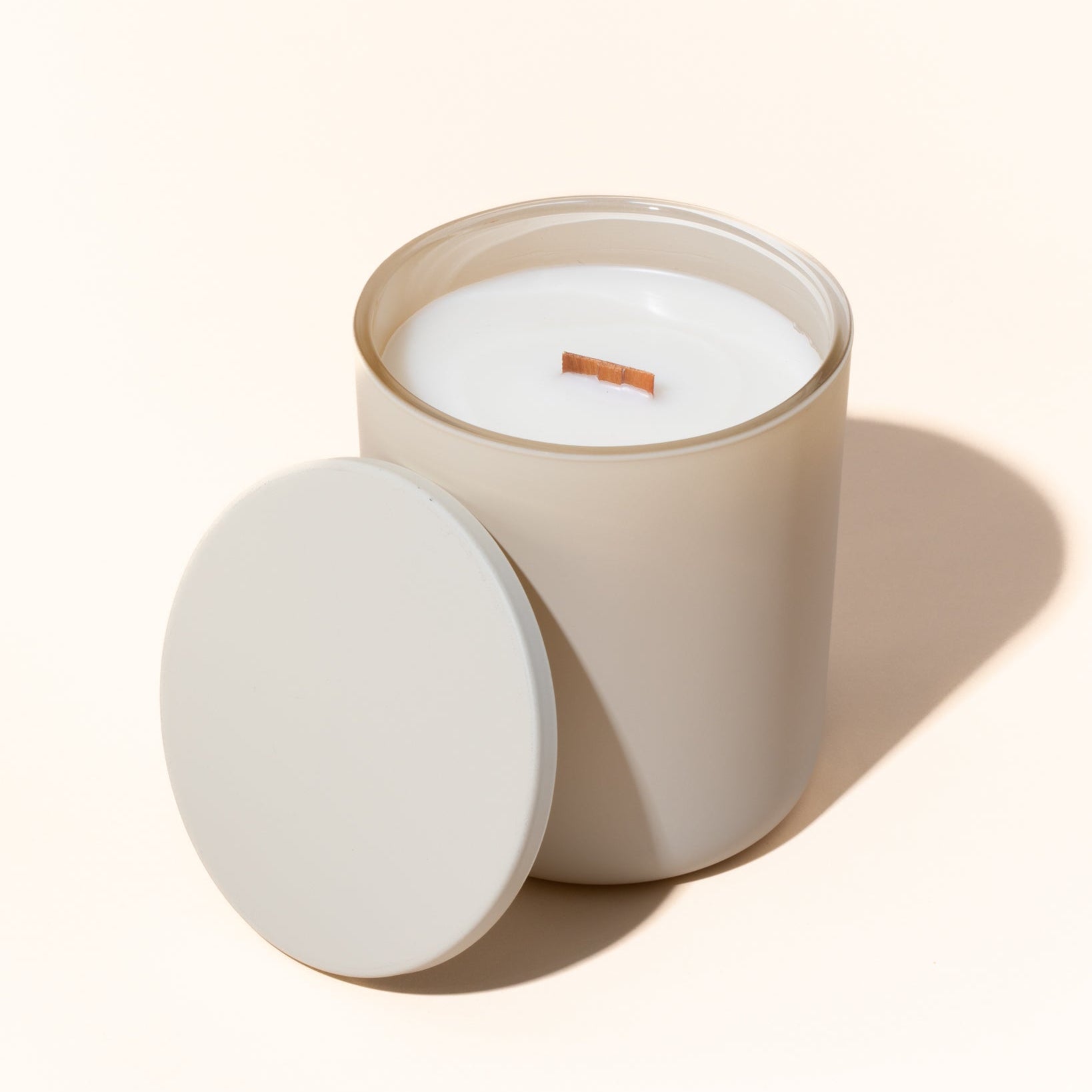 Matte cream metal candle lids styled with 12 oz Aura candle jars from above