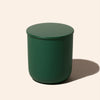 Green cylindrical container on a beige background