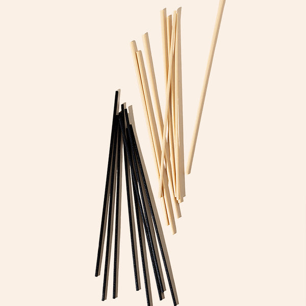 Black and natural fiber diffuser reeds 8 inch set of 100 by makesy laid flat on a surface
