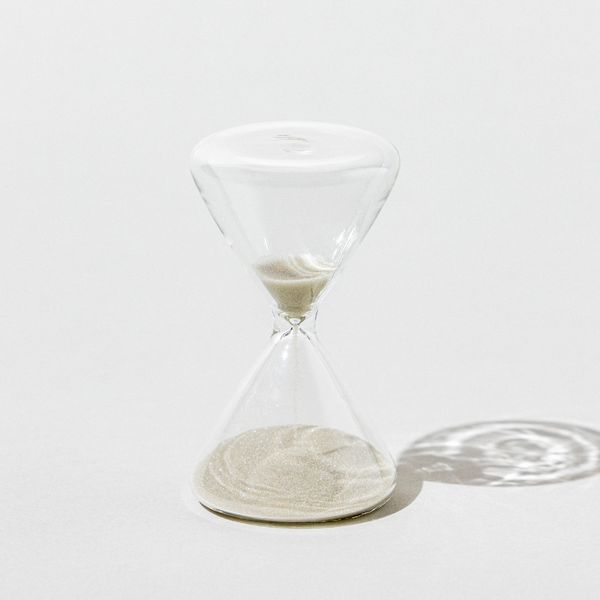 Clear hourglass on a white background