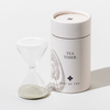 White tea timer with a glass container on a white background