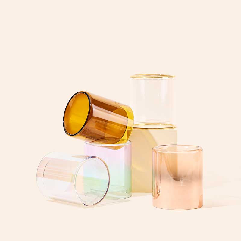 Lifestyle shot of makesy 11oz Allure™ double glass candle vessels styled on a surface
