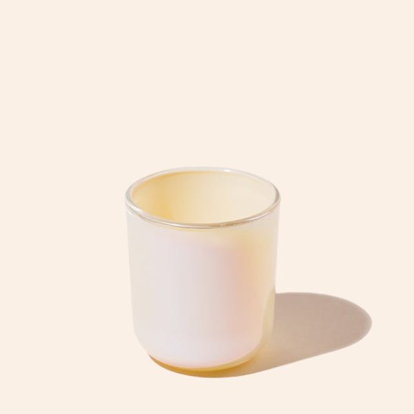 White ceramic tumbler with a subtle gradient on a light beige background