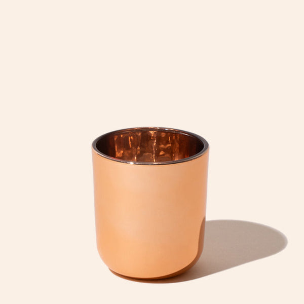 Copper tumbler on a beige background