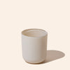White ceramic cup on a beige background