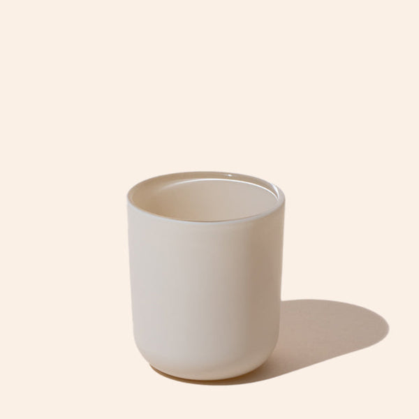 White ceramic cup on a beige background
