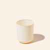 White ceramic cup on a beige background