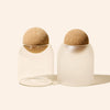 Set of 12 Luna™ 7oz candle vessels grouped together with cork ball stopper