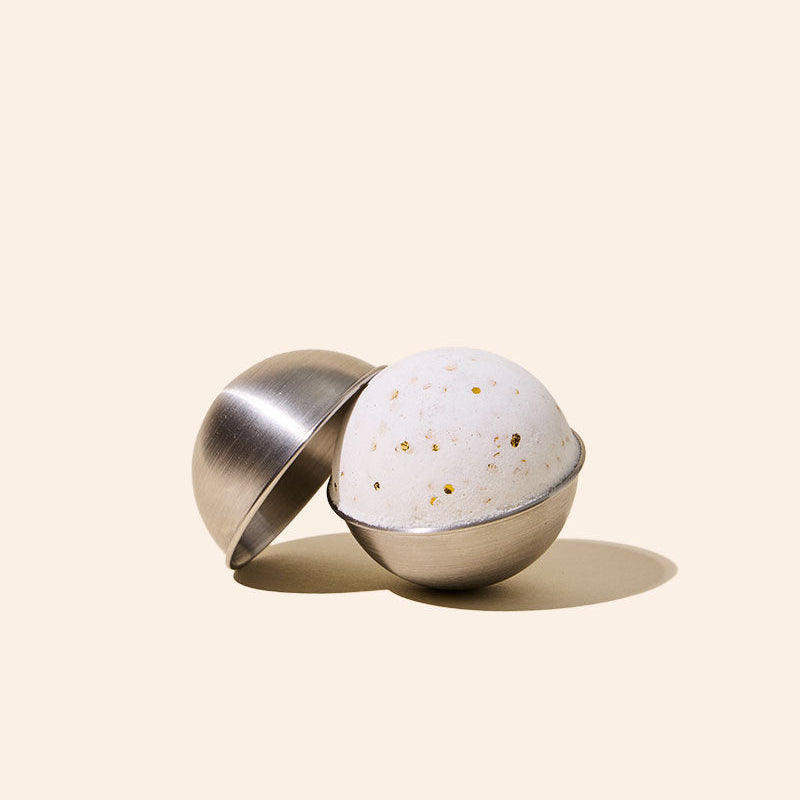 Close-up of stainless steel bath bomb mold showing smooth finish and construction detail