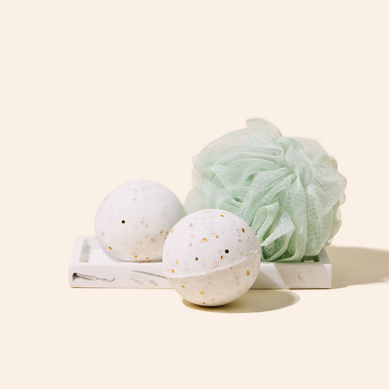Two-piece stainless steel bath bomb mold open and closed on a flat surface