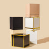 Makesy rigid square candle gift boxes in multiple colors displayed together on a flat surface