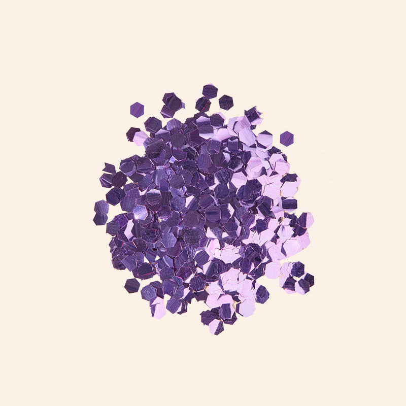 Purple and pink gemstones on a light pink background