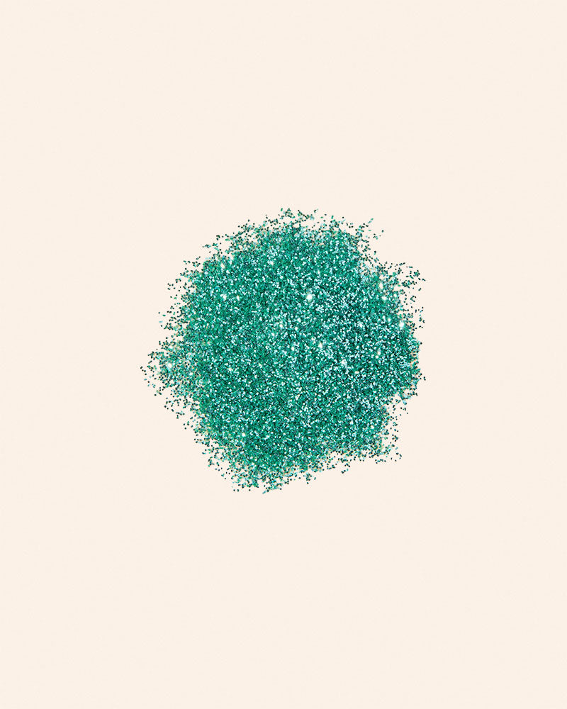 Turquoise sand-like material on a beige background