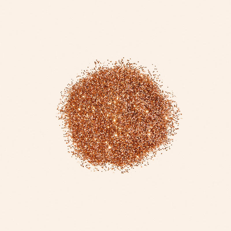 Brown glitter powder on a beige background