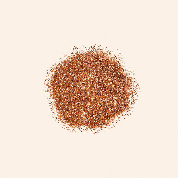 Brown glitter powder on a beige background