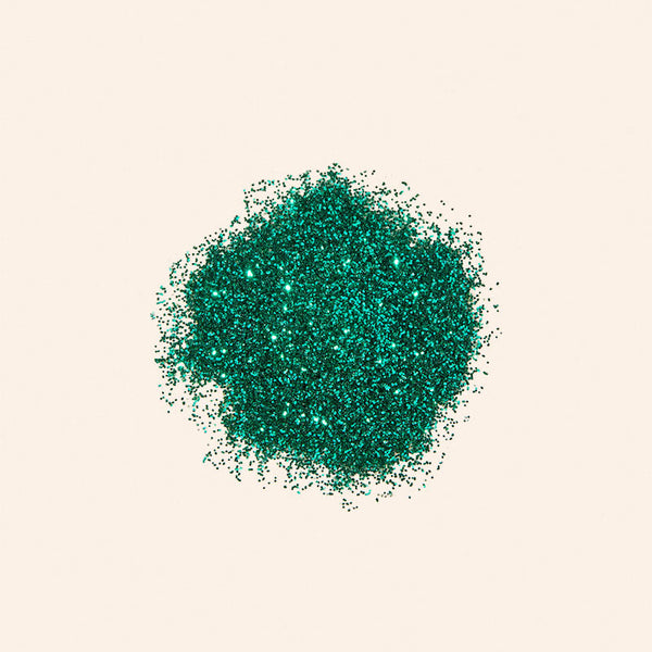 Green glitter on a beige background