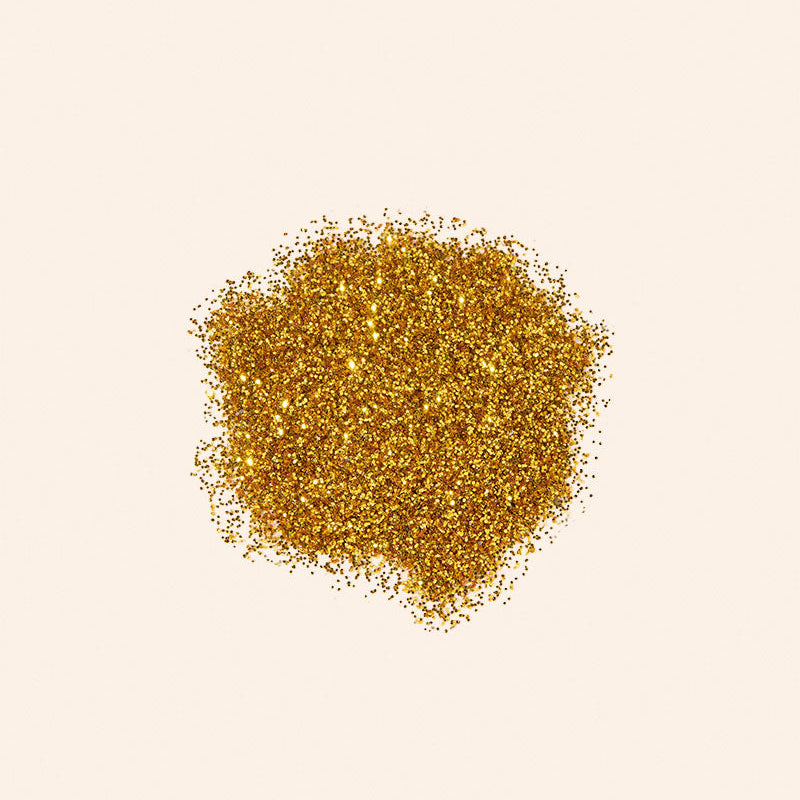 Gold glitter on a beige background