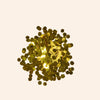 Gold metallic confetti on a beige background