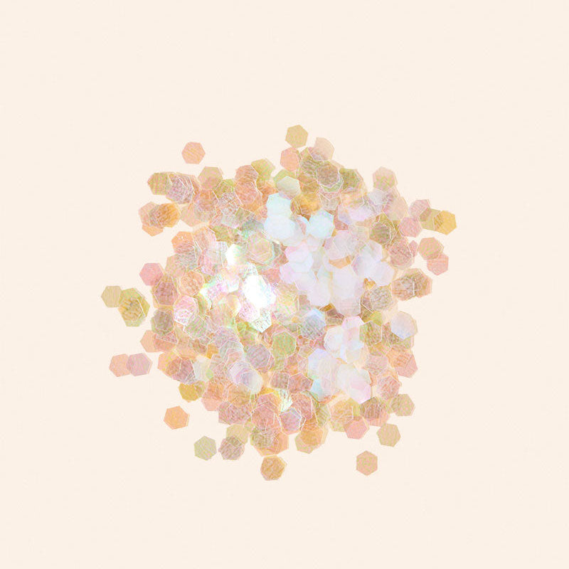 Pastel-colored confetti on a light beige background