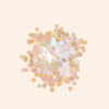 Pastel-colored confetti on a light beige background