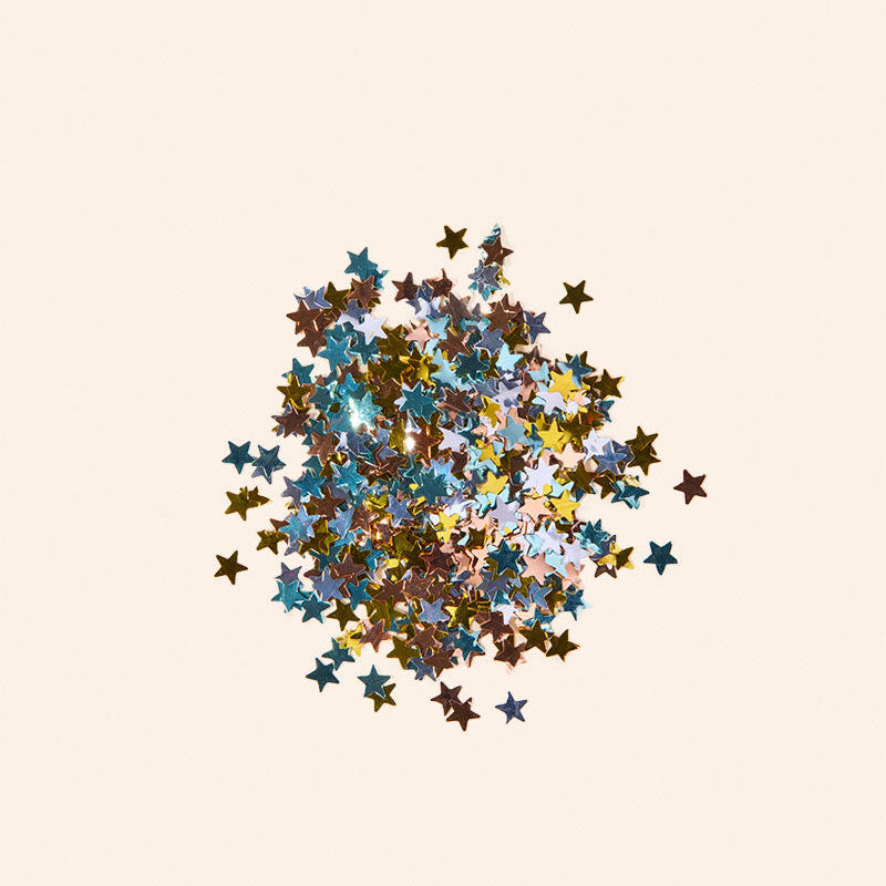 Colorful star-shaped confetti on a beige background
