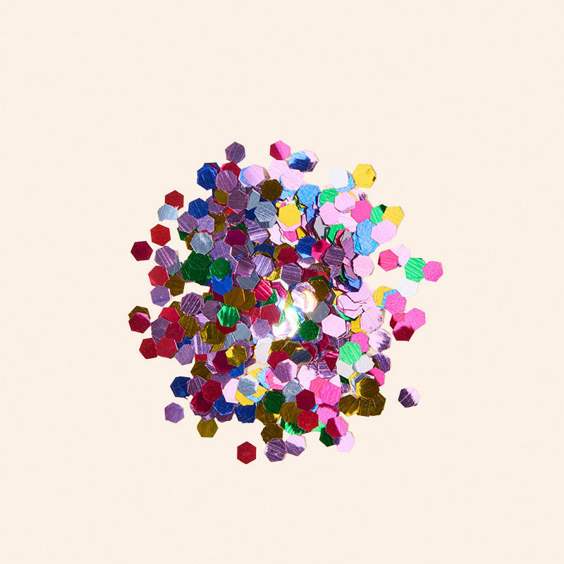 Colorful confetti on a beige background