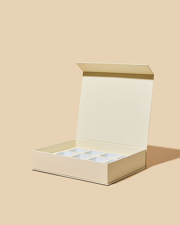 Beige jewelry box with a clear lid on a beige background
