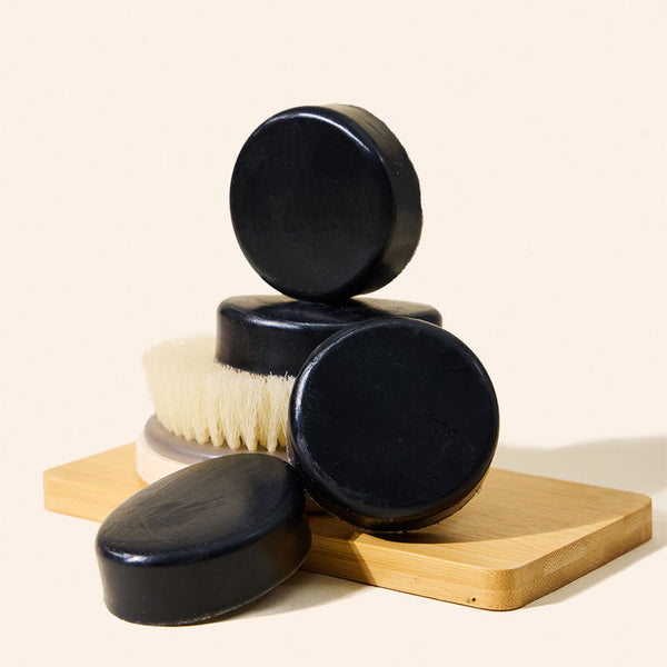 Close-up of makesy black charcoal melt and pour soap base showing smooth texture and rich black tone