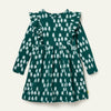 Girl wearing Mon Coeur Snowy Pine Ruffle Dress in recycled organic cotton fleece, front view