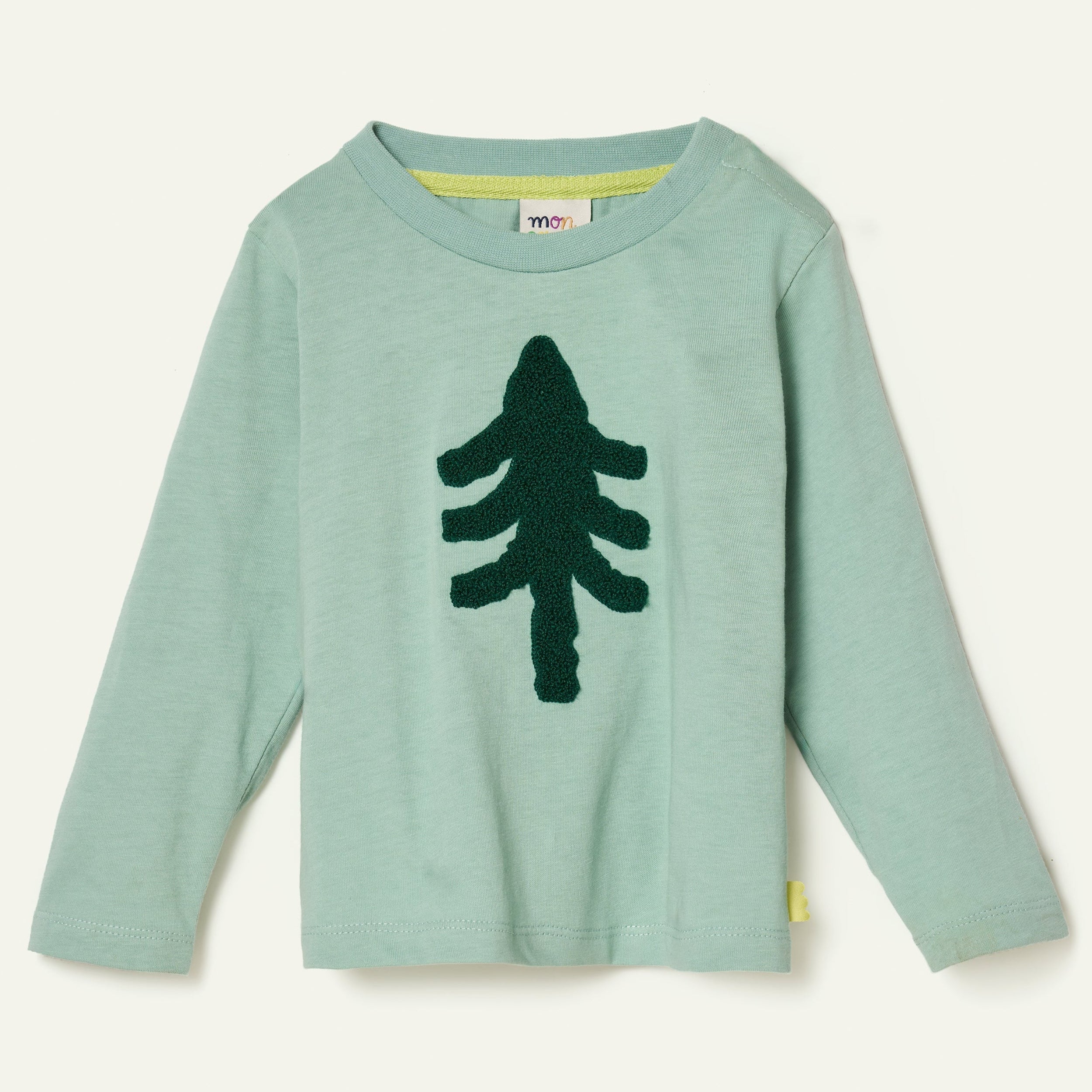 Child wearing the Mon Coeur Snowy Pine long-sleeve T-shirt with boucle embroidered pine tree detail, front view